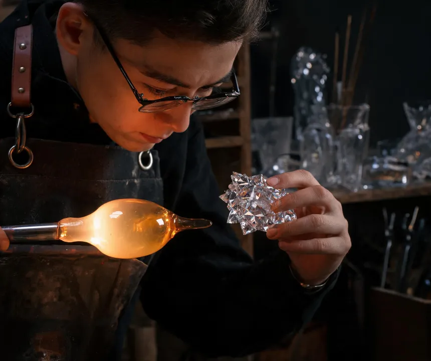 Glass artisan shaping crystal